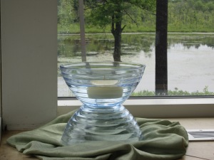 A floating candle in a pair of inverted bowls add light and interesting reflective surfaces to an already serene view.